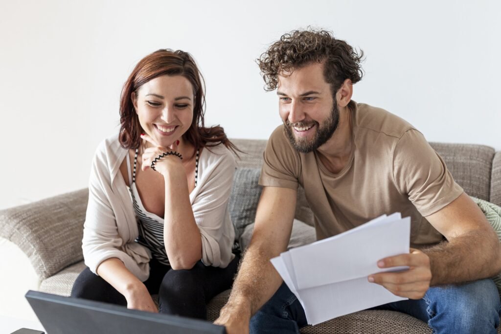 Happy couple after discovering the effect of net metering on their electric bill.